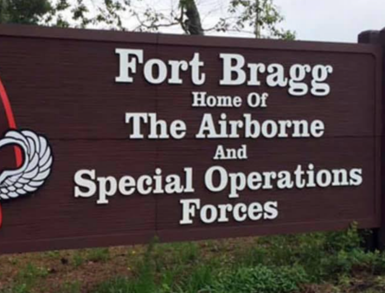 Sign reading 'Fort Bragg' at the entrance of the historic military installation, symbolizing its legacy and connection to U.S. military history.